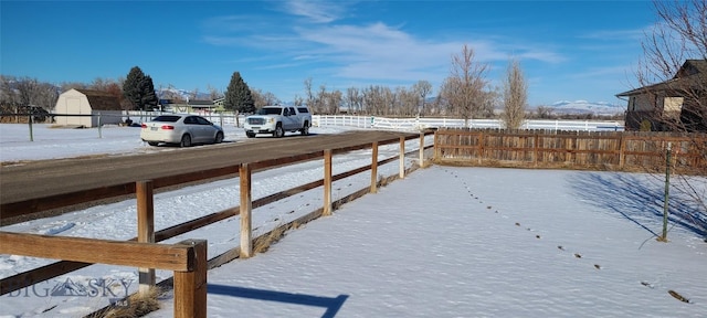 snowy yard with fence