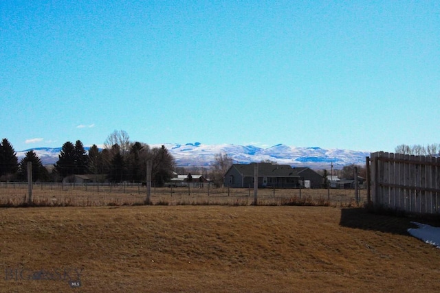 view of yard with fence and a mountain view