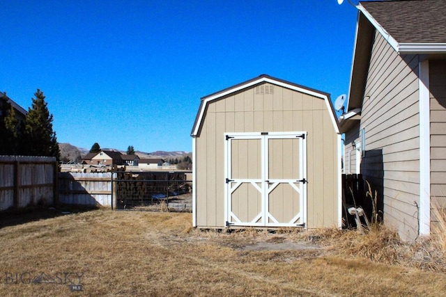 view of shed with fence