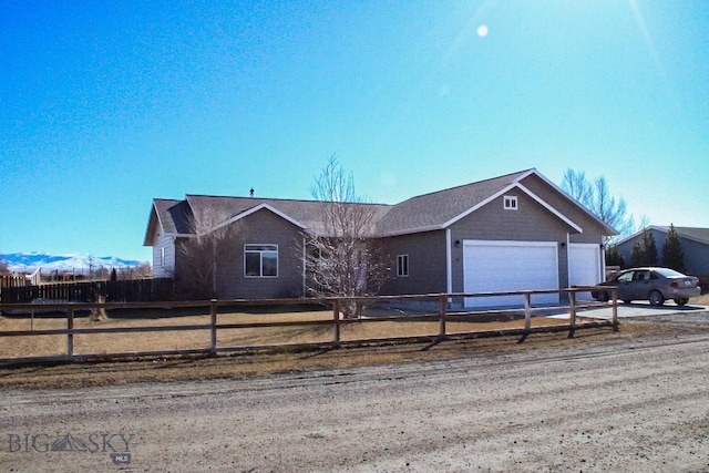 single story home with an attached garage, fence, and concrete driveway