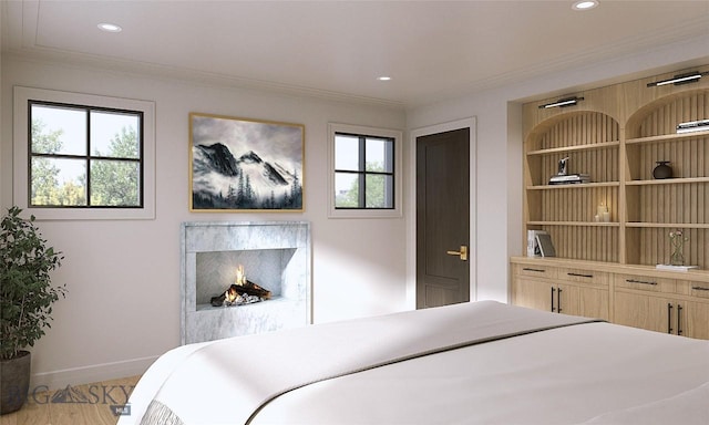 bedroom with light wood-type flooring and ornamental molding