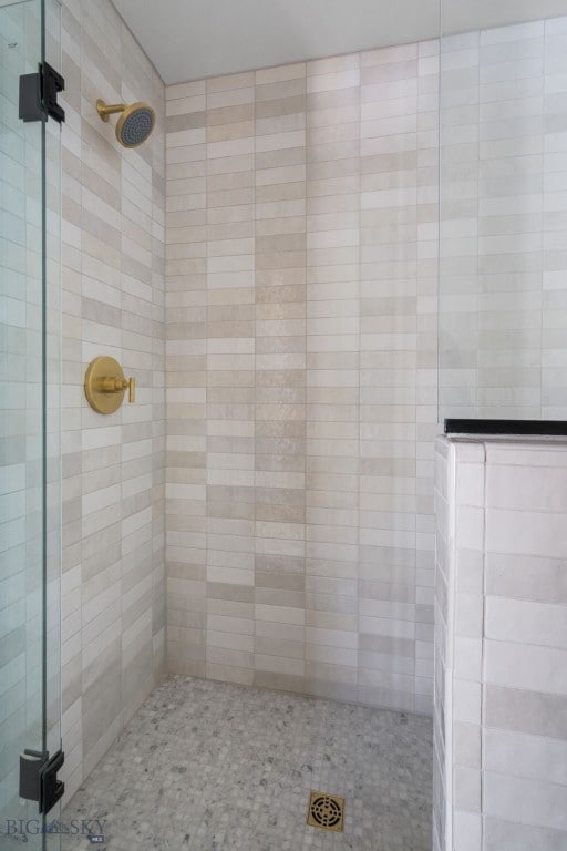 bathroom with a shower with door