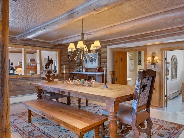 107 Dry Creek Trl, Ennis, MT 59729 - dining room featuring beamed ceiling, a chandelier, log walls, a baseboard radiator, and baseboard heating
