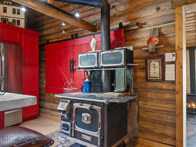 107 Dry Creek Trl, Ennis, MT 59729 - detailed view of freestanding refrigerator, rustic walls, and wood finished floors