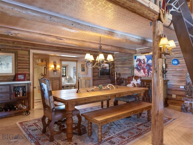 107 Dry Creek Trl, Ennis, MT 59729 - dining area featuring rustic walls, a chandelier, beam ceiling, and light wood-style floors