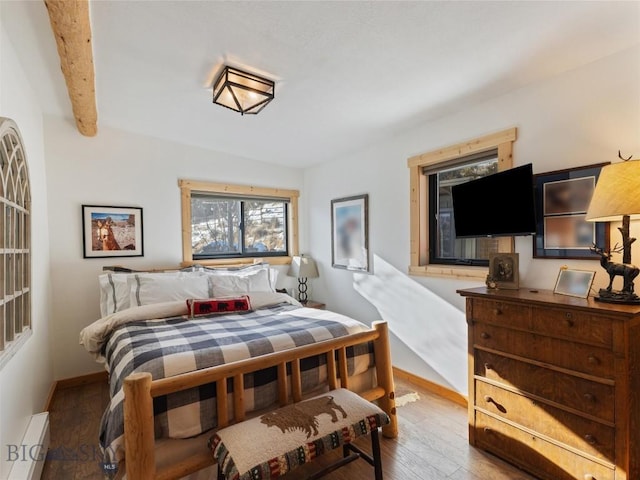 107 Dry Creek Trl, Ennis, MT 59729 - bedroom with baseboards, wood finished floors, and lofted ceiling