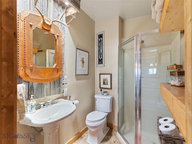 107 Dry Creek Trl, Ennis, MT 59729 - bathroom with a stall shower, toilet, backsplash, and baseboards
