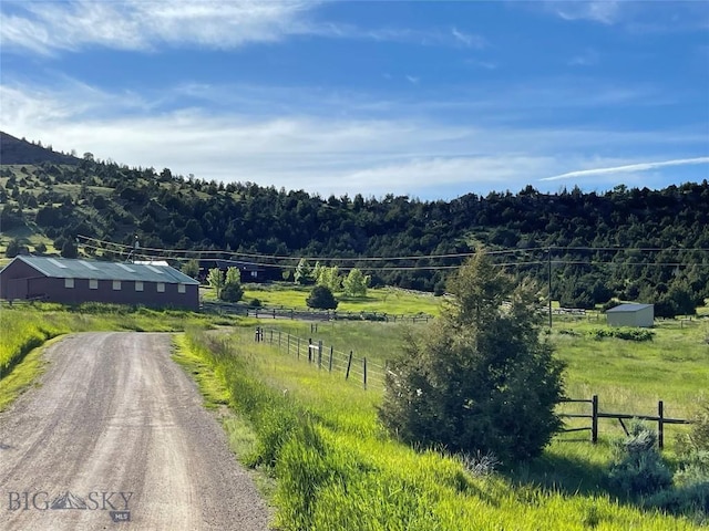 107 Dry Creek Trl, Ennis, MT 59729 - view of mountain background featuring rural landscape and a heavily wooded area