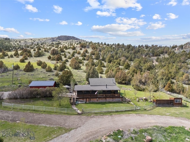 107 Dry Creek Trl, Ennis, MT 59729 - aerial view of sparsely populated area with a mountain backdrop and a heavily wooded area