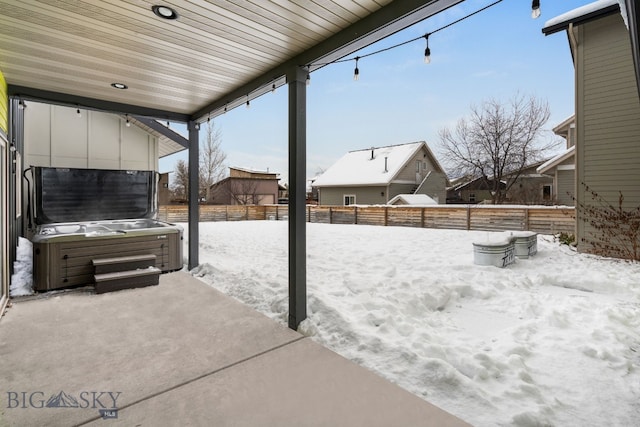 snow covered patio with a hot tub