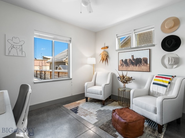 sitting room featuring ceiling fan