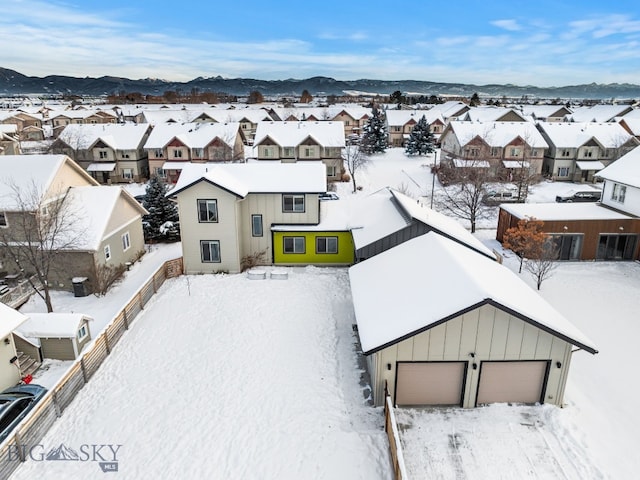 snowy aerial view featuring a mountain view