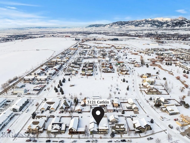 snowy aerial view with a mountain view