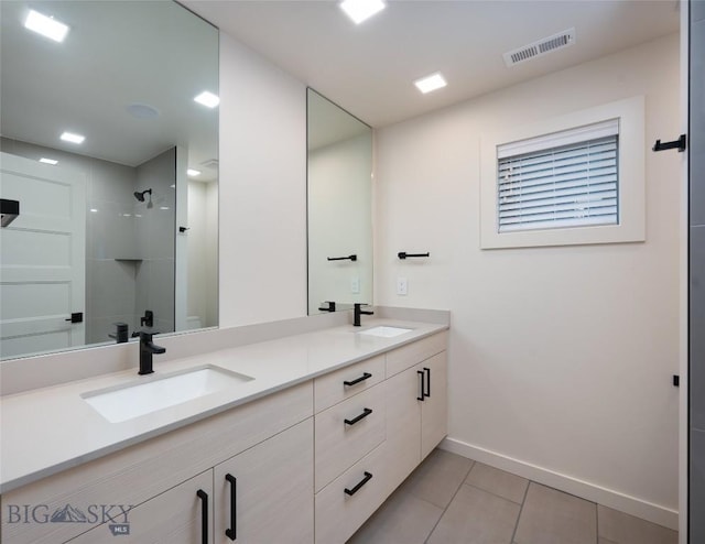 bathroom featuring walk in shower, vanity, and tile patterned flooring