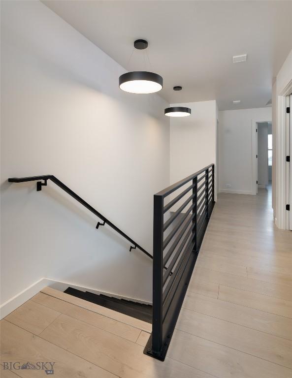 stairway with hardwood / wood-style flooring