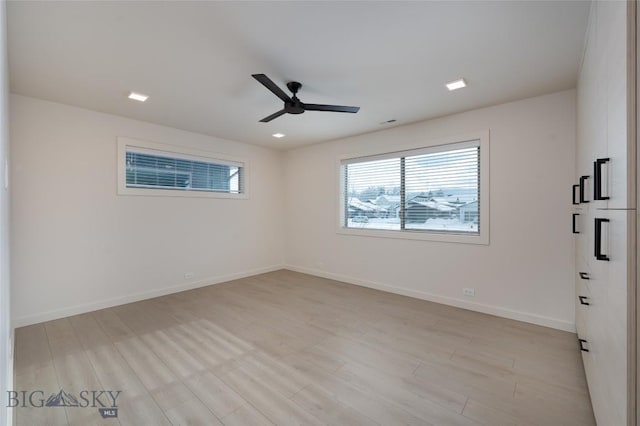 spare room featuring ceiling fan and light hardwood / wood-style floors