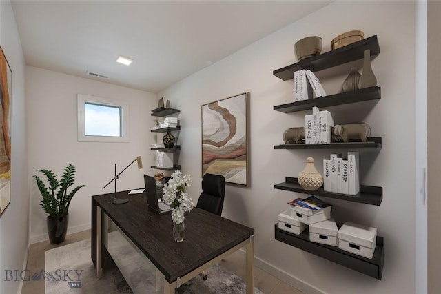 office space with wood-type flooring