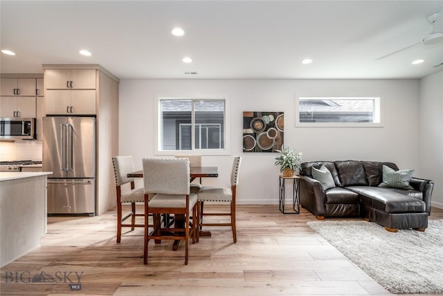 dining room featuring ceiling fan and light wood-type flooring