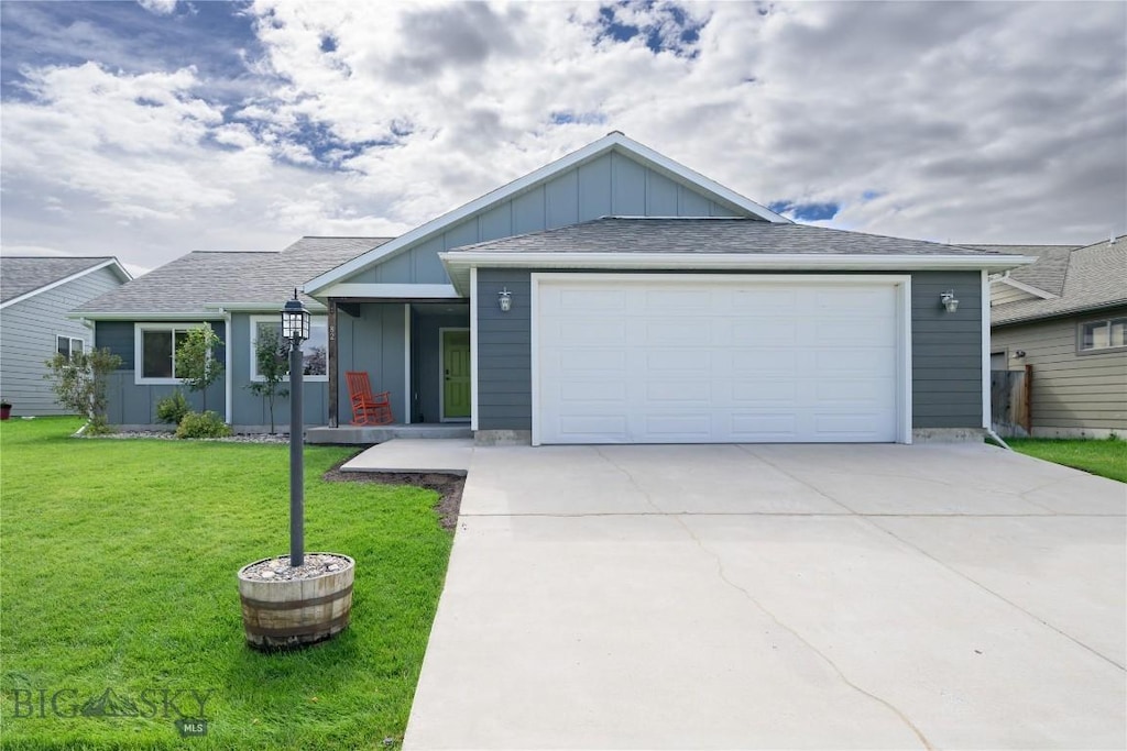 ranch-style home featuring a front yard and a garage