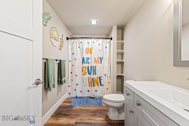 bathroom with wood-type flooring, toilet, a shower with shower curtain, and vanity