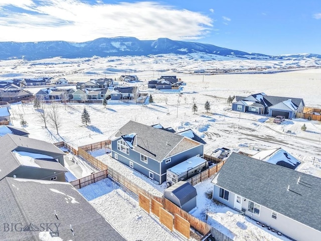 snowy aerial view with a mountain view