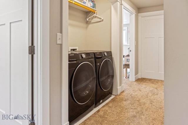 laundry area with light carpet and independent washer and dryer