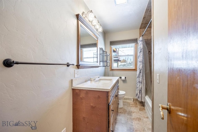 full bathroom with toilet, vanity, and shower / tub combo with curtain