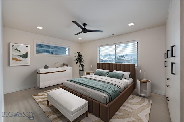 bedroom with ceiling fan and light hardwood / wood-style floors
