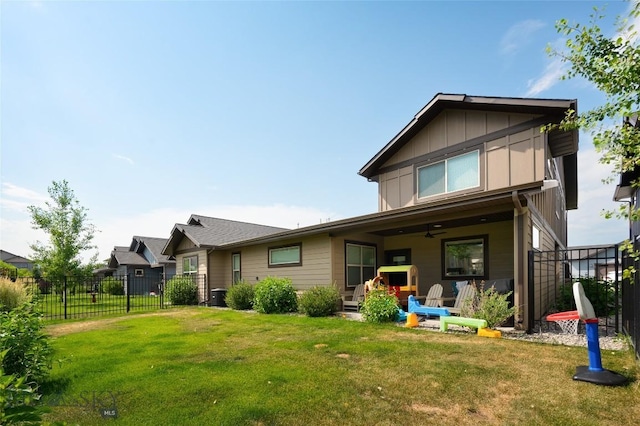 back of house featuring a lawn