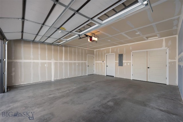 garage with electric panel and a garage door opener