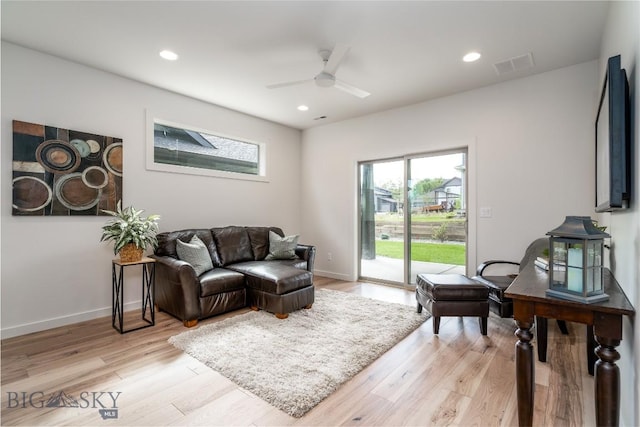living room featuring ceiling fan and light hardwood / wood-style flooring