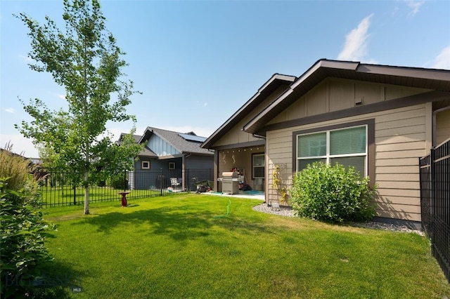 back of house with a lawn