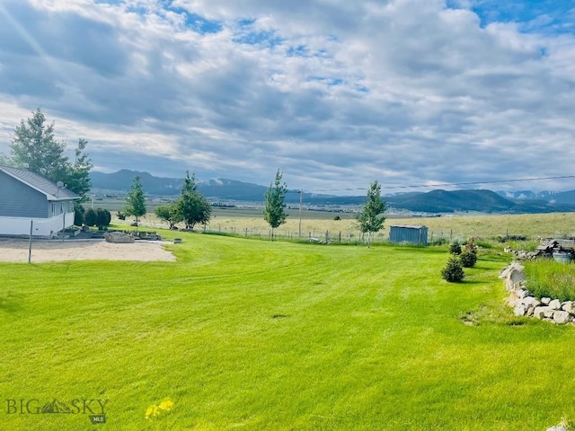 view of yard featuring a rural view and a mountain view