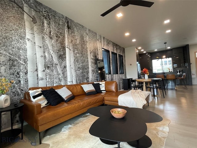 living area featuring recessed lighting, ceiling fan, and light wood finished floors