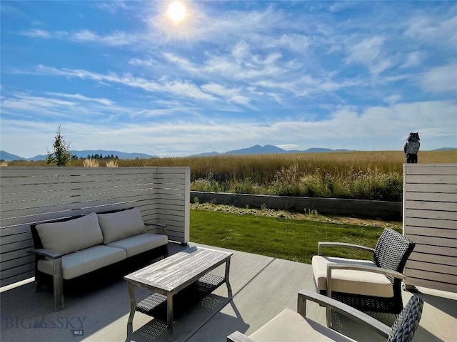 view of patio / terrace with an outdoor living space and a mountain view