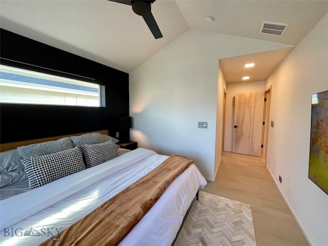 bedroom featuring visible vents, baseboards, lofted ceiling, light wood-style floors, and a ceiling fan