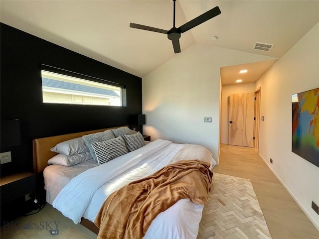 bedroom with light wood-style floors, lofted ceiling, a ceiling fan, and visible vents