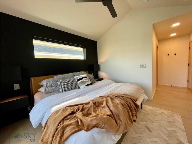 bedroom with light hardwood / wood-style floors, vaulted ceiling, and ceiling fan