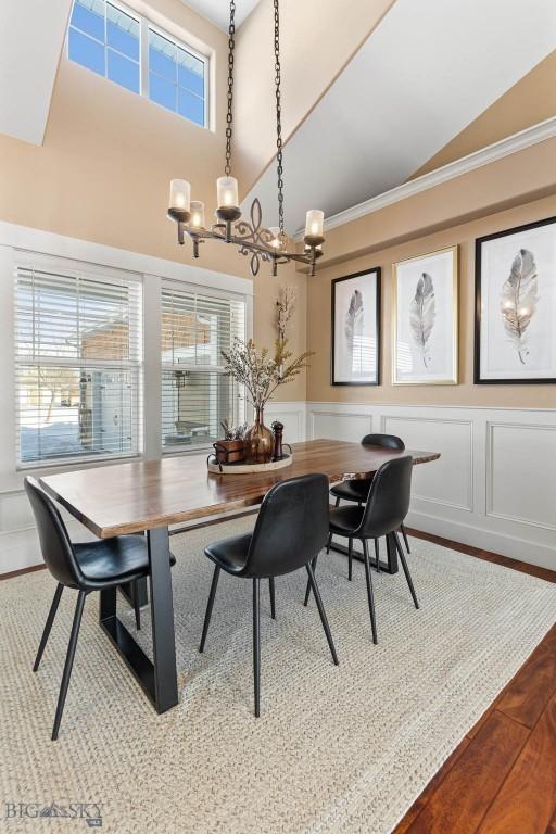 dining area with hardwood / wood-style floors and crown molding