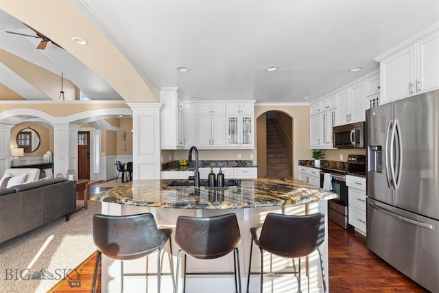 kitchen featuring crown molding, white cabinets, ornate columns, and stainless steel appliances