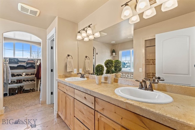 bathroom with a wealth of natural light and vanity