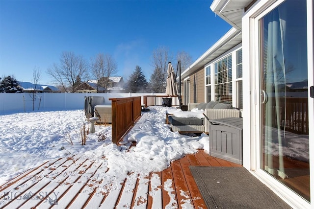 yard covered in snow with a deck