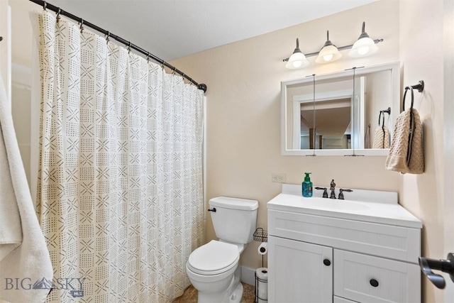 bathroom featuring vanity, toilet, and curtained shower