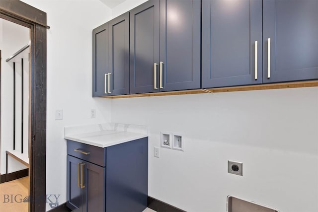 laundry area with washer hookup, electric dryer hookup, and cabinets