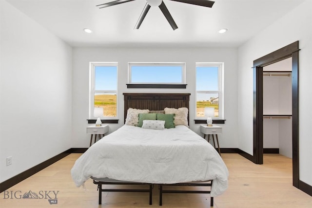 bedroom with ceiling fan and light hardwood / wood-style flooring