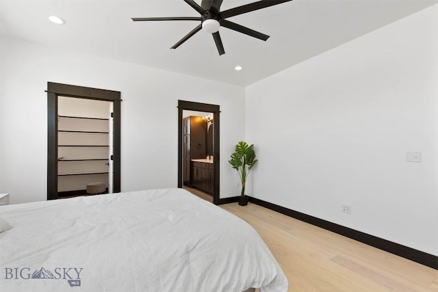 bedroom featuring ceiling fan, ensuite bathroom, and hardwood / wood-style flooring