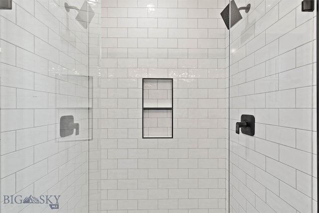 bathroom with a tile shower