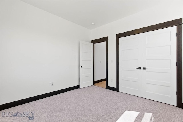 unfurnished bedroom featuring light carpet