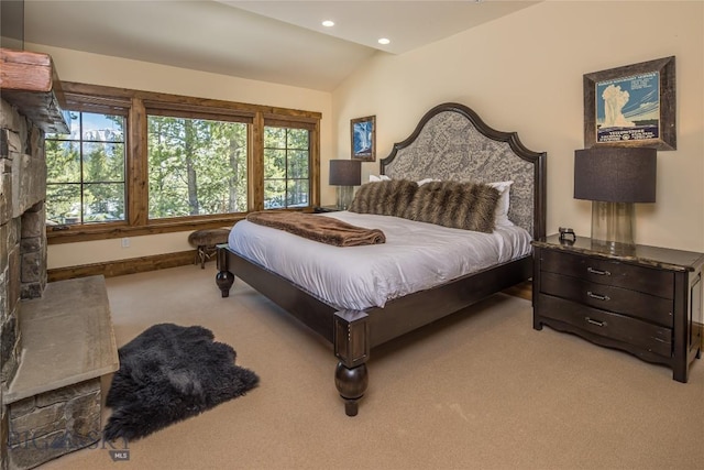 bedroom featuring light carpet and lofted ceiling