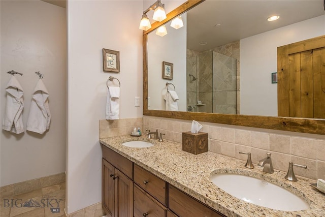 bathroom featuring vanity, tasteful backsplash, and an enclosed shower